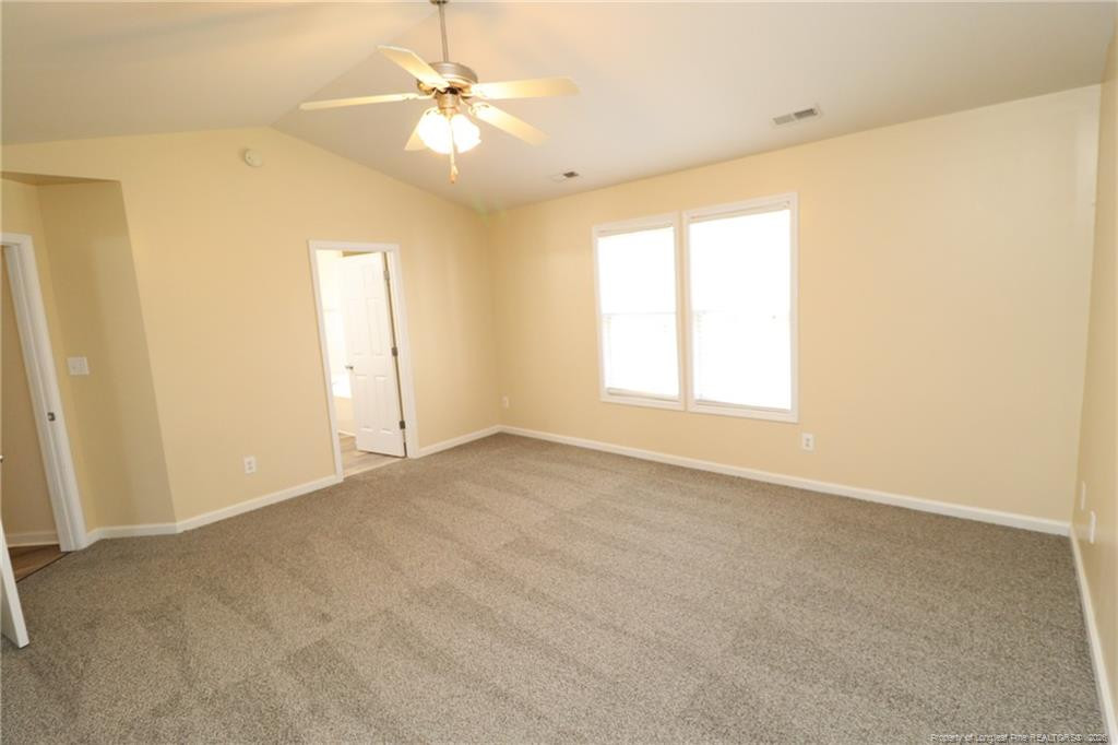 2936 Filbert Street Raleigh, NC 27610 - Photo 14 of 27 an empty room with windows and ceiling fan