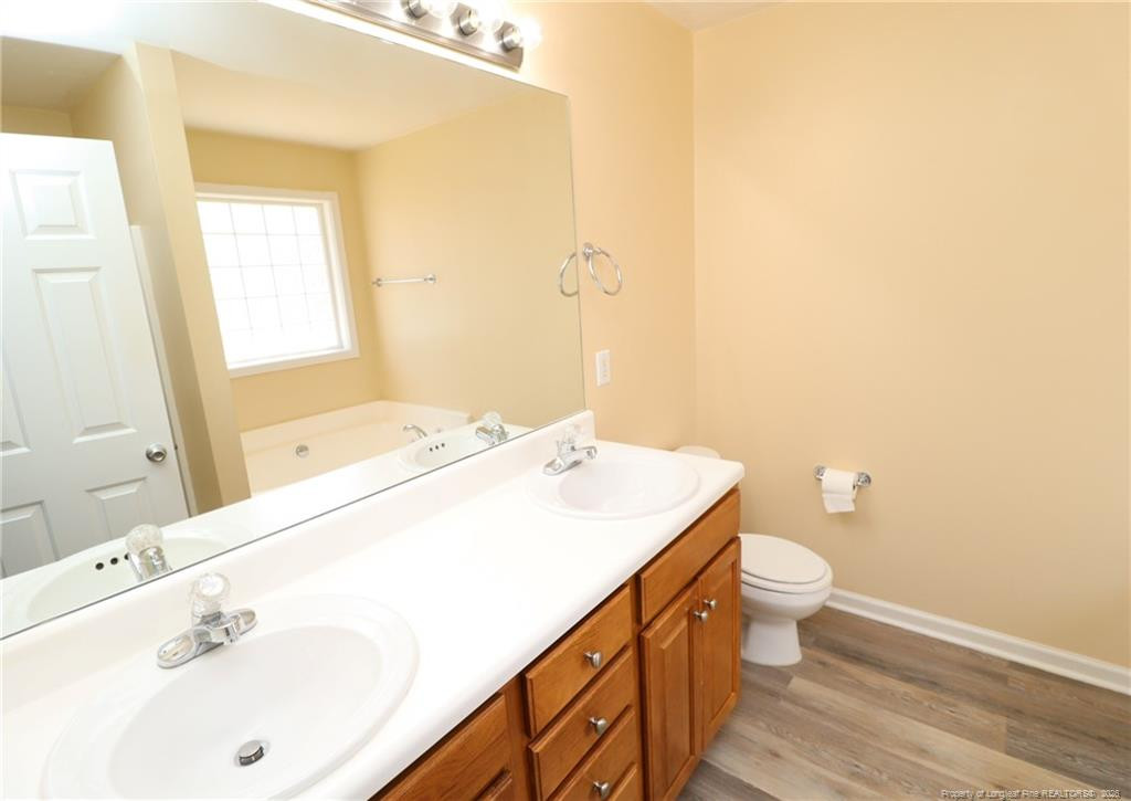 2936 Filbert Street Raleigh, NC 27610 - Photo 17 of 27 a bathroom with a sink and a mirror