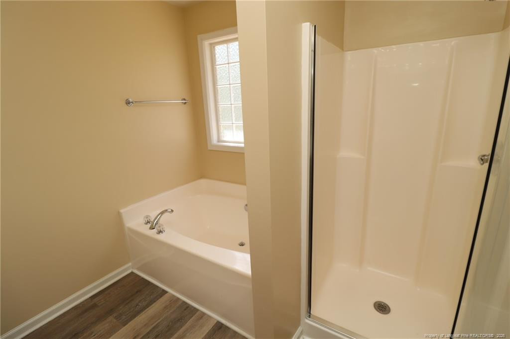 2936 Filbert Street Raleigh, NC 27610 - Photo 18 of 27 a bathroom with a tub and shower