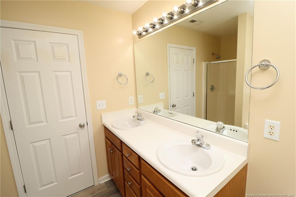2936 Filbert Street Raleigh, NC 27610 - Photo 19 of 27 a bathroom with a sink and a mirror