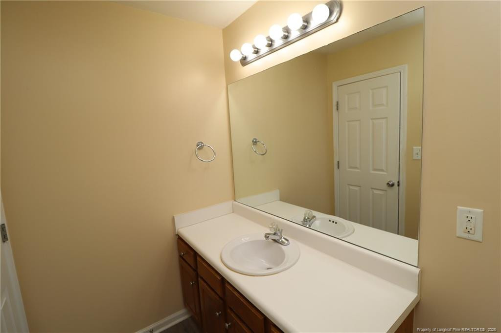 2936 Filbert Street Raleigh, NC 27610 - Photo 24 of 27 a bathroom with a sink and a mirror