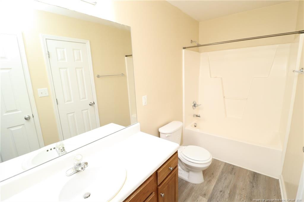 2936 Filbert Street Raleigh, NC 27610 - Photo 25 of 27 a bathroom with a sink a toilet and shower