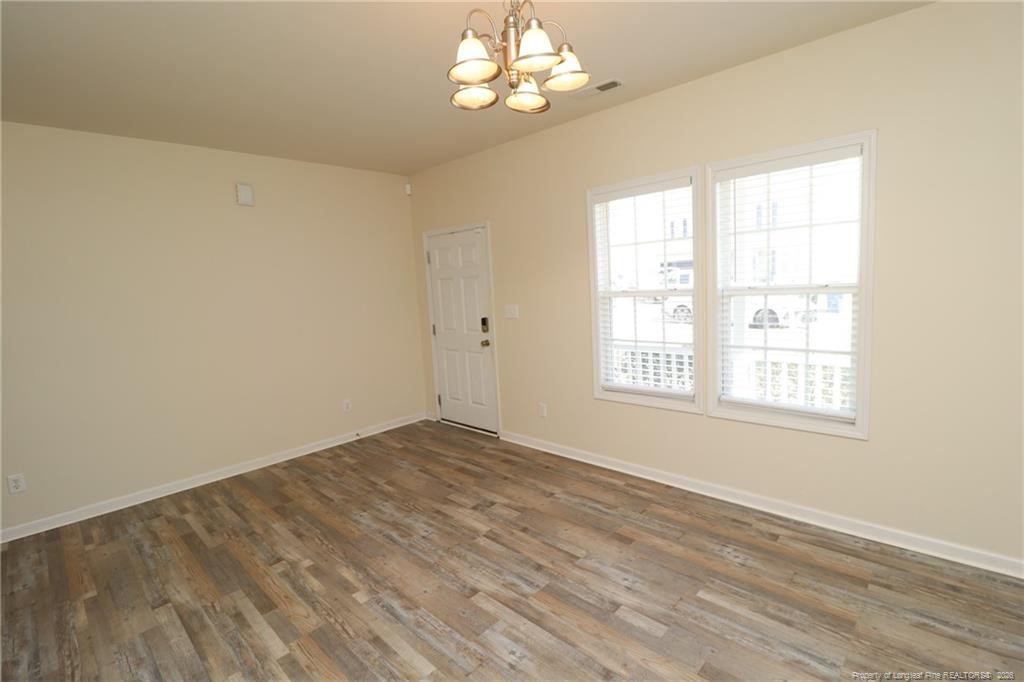 2936 Filbert Street Raleigh, NC 27610 - Photo 3 of 27 a view of empty room with wooden floor and fan