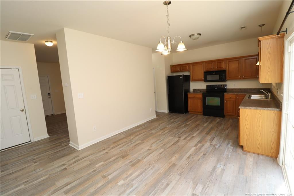 2936 Filbert Street Raleigh, NC 27610 - Photo 8 of 27 a view of a kitchen with a sink and refrigerator