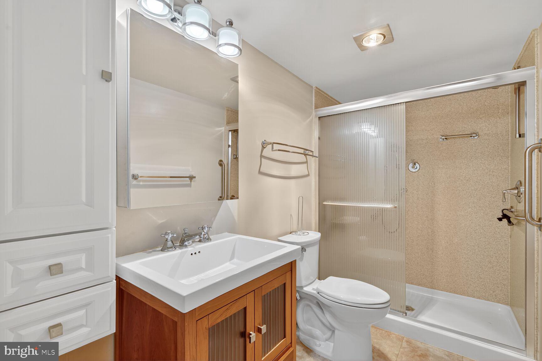 15101 Interlachen Drive, Unit 1123 Silver Spring, MD 20906 - Photo 15 of 29 a bathroom with a sink toilet and shower