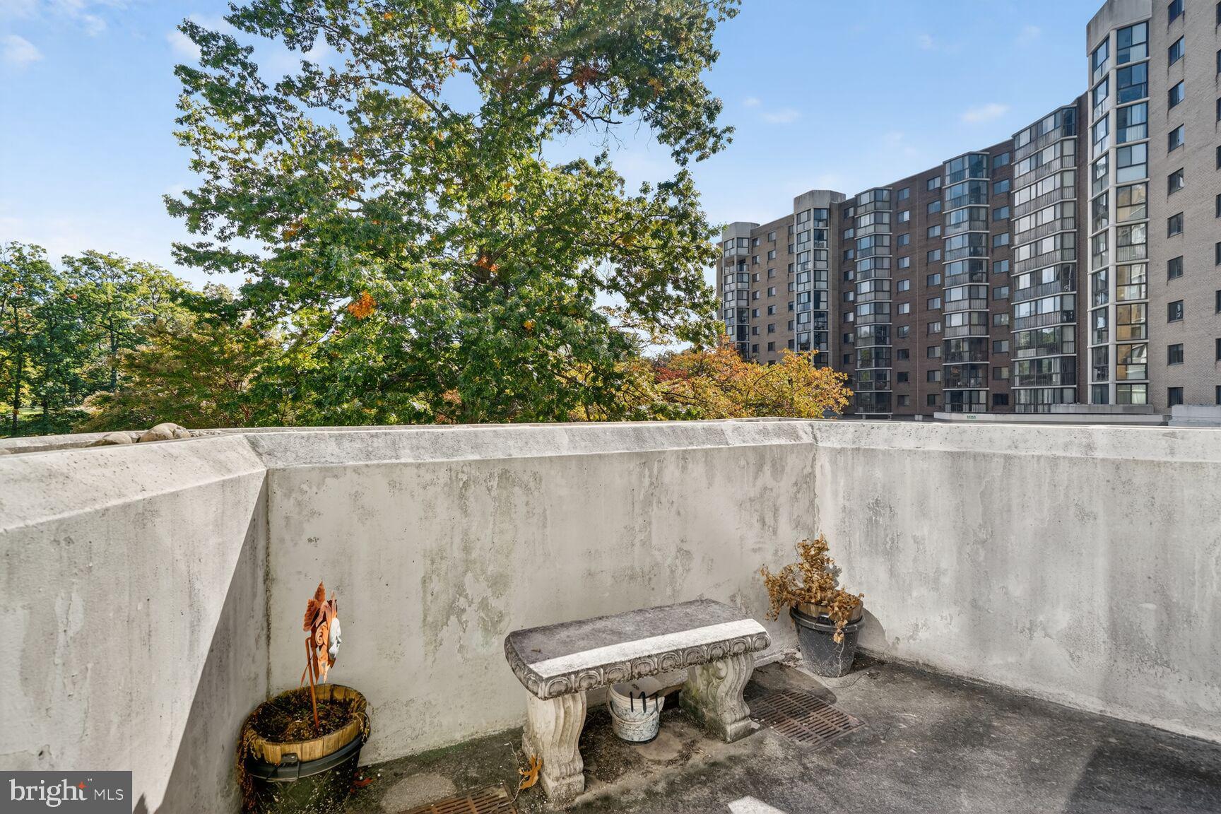 15101 Interlachen Drive, Unit 1123 Silver Spring, MD 20906 - Photo 18 of 29 a bathroom with a toilet and a shower curtain
