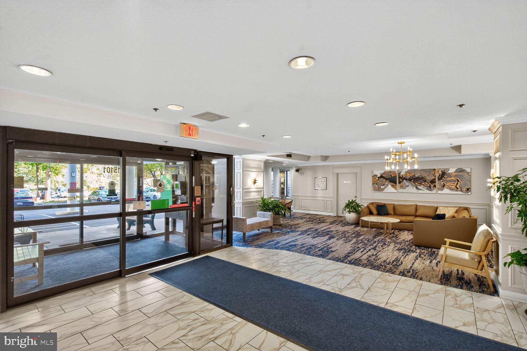 15101 Interlachen Drive, Unit 1123 Silver Spring, MD 20906 - Photo 19 of 29 a living room with furniture a floor to ceiling window and wooden floor