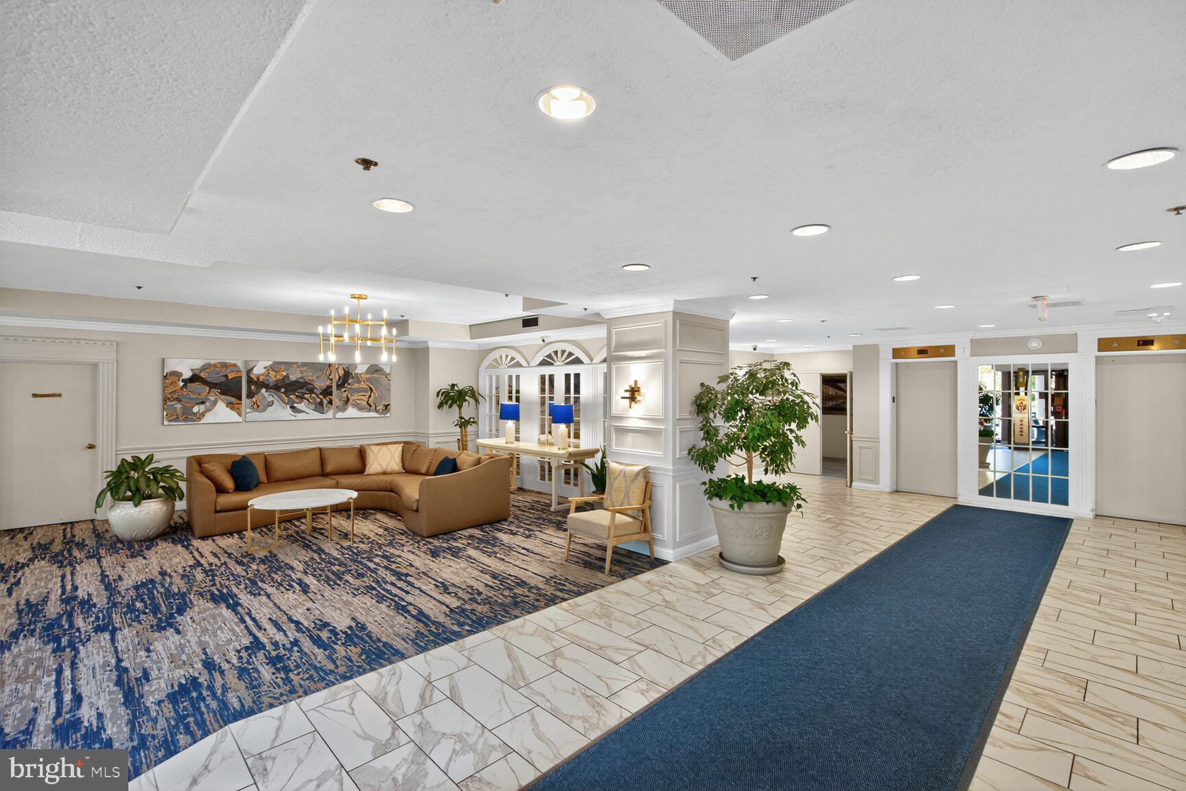 15101 Interlachen Drive, Unit 1123 Silver Spring, MD 20906 - Photo 21 of 29 a living room with furniture and potted plant