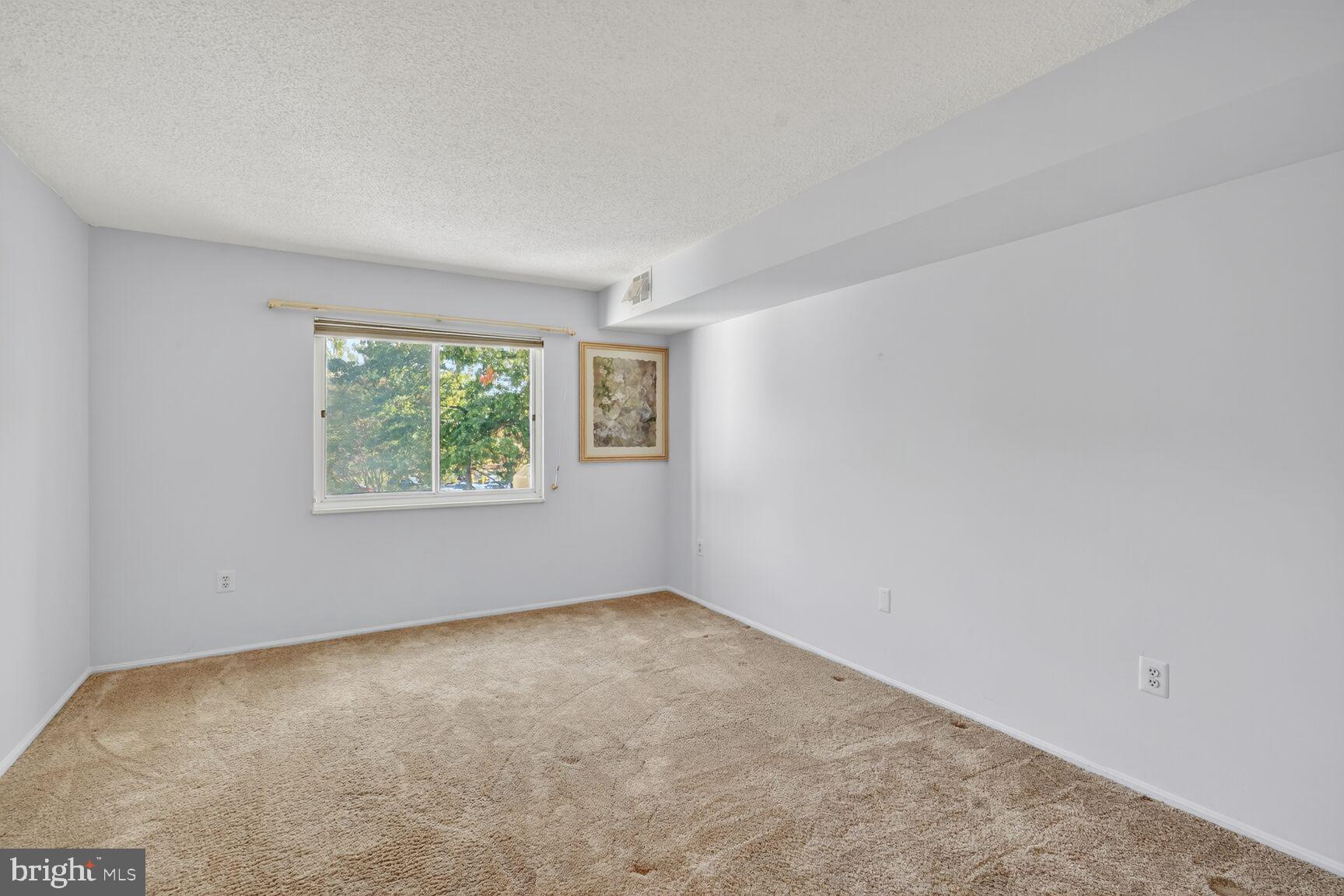 15101 Interlachen Drive, Unit 1123 Silver Spring, MD 20906 - Photo 9 of 29 an empty room with windows