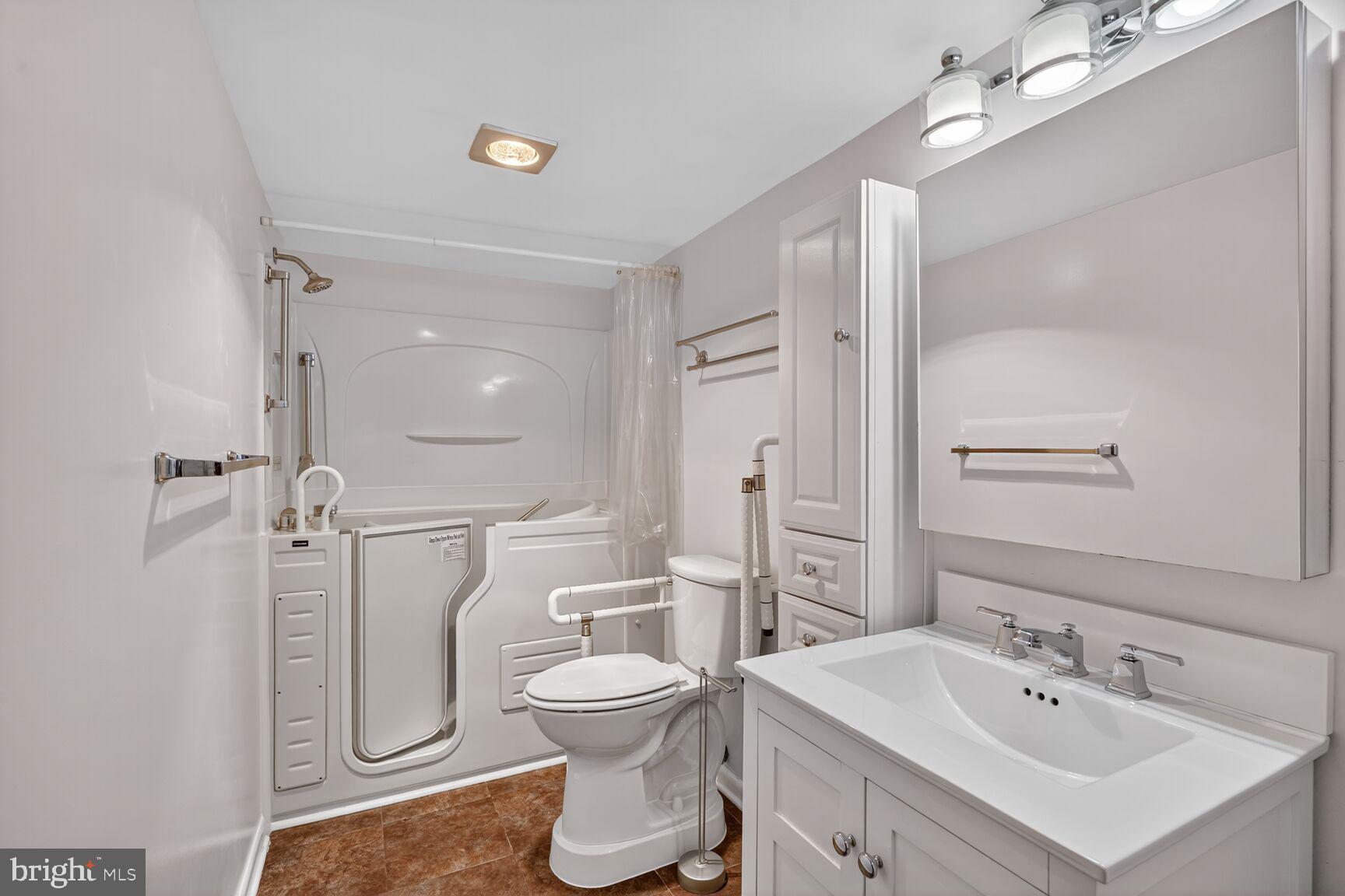 15101 Interlachen Drive, Unit 1123 Silver Spring, MD 20906 - Photo 10 of 29 a bathroom with a toilet sink and shower