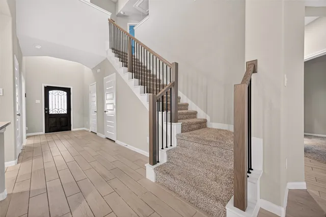 a view of entryway and hall with wooden floor