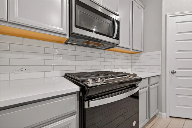 a stove top oven sitting inside of a kitchen