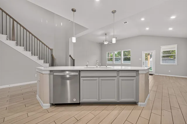a kitchen with granite countertop a white stove top oven and cabinets