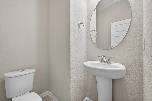 a bathroom with a sink a mirror and toilet