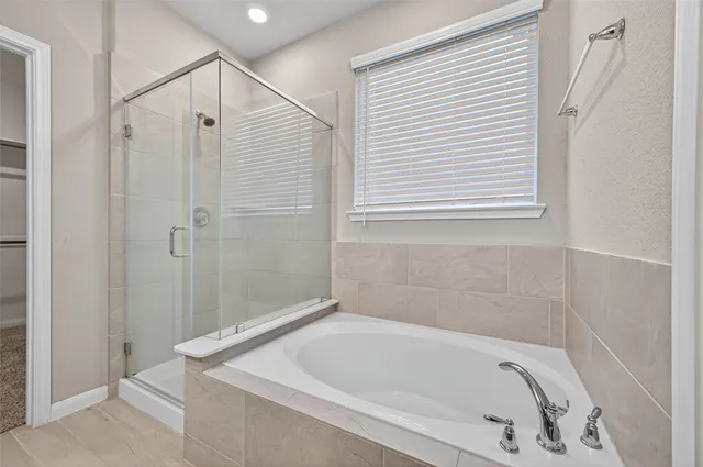 a bathroom with a tub and a shower