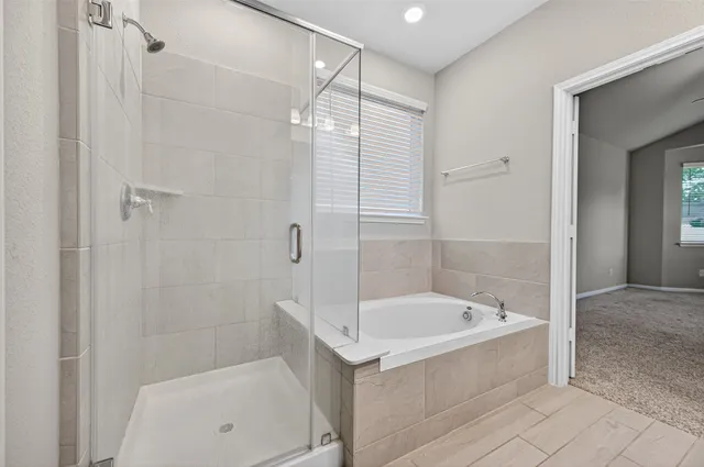 a white bath tub sitting next to a shower