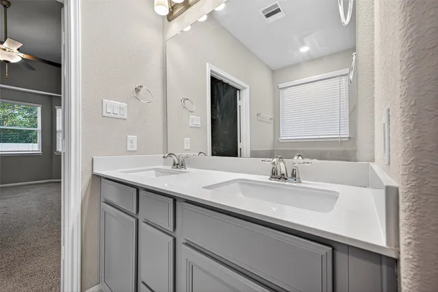 a bathroom with a sink double vanity and a mirror