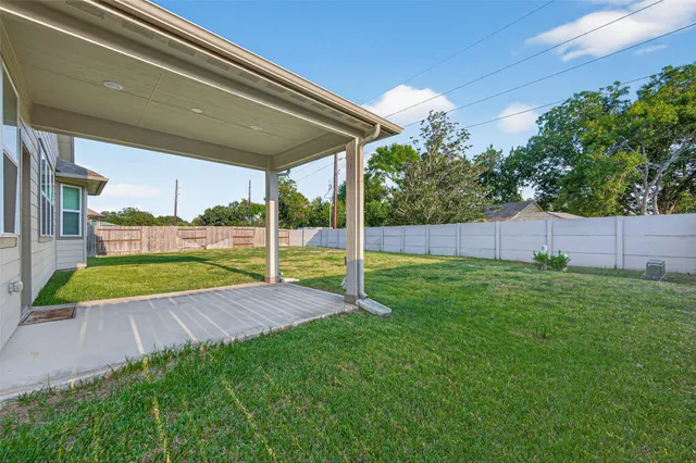 a view of a house with a yard and sitting area