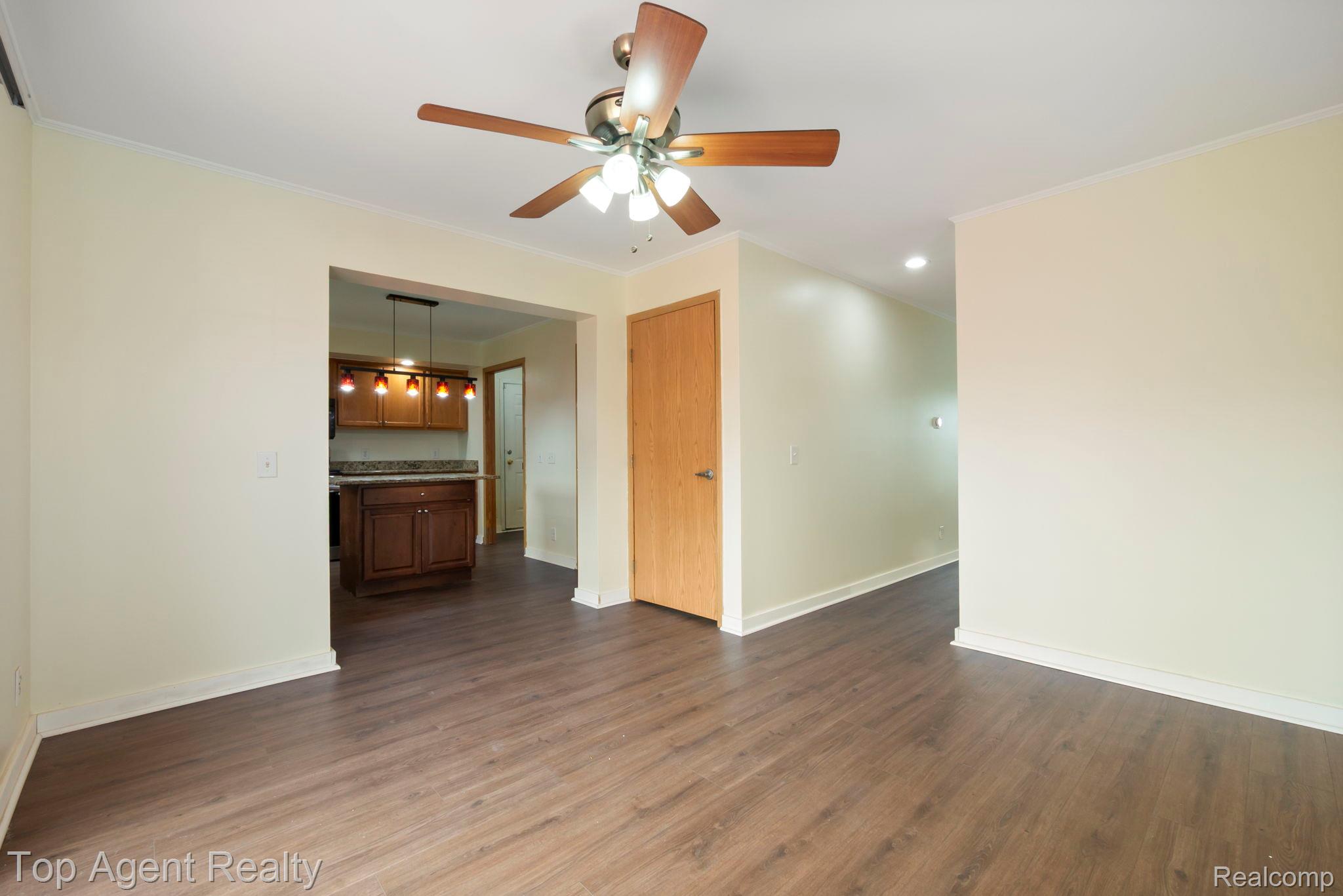 2018 John R Road Troy, MI 48083 - Photo 7 of 30 Unfurnished room featuring ornamental molding, dark wood-style flooring, a ceiling fan, and recessed lighting