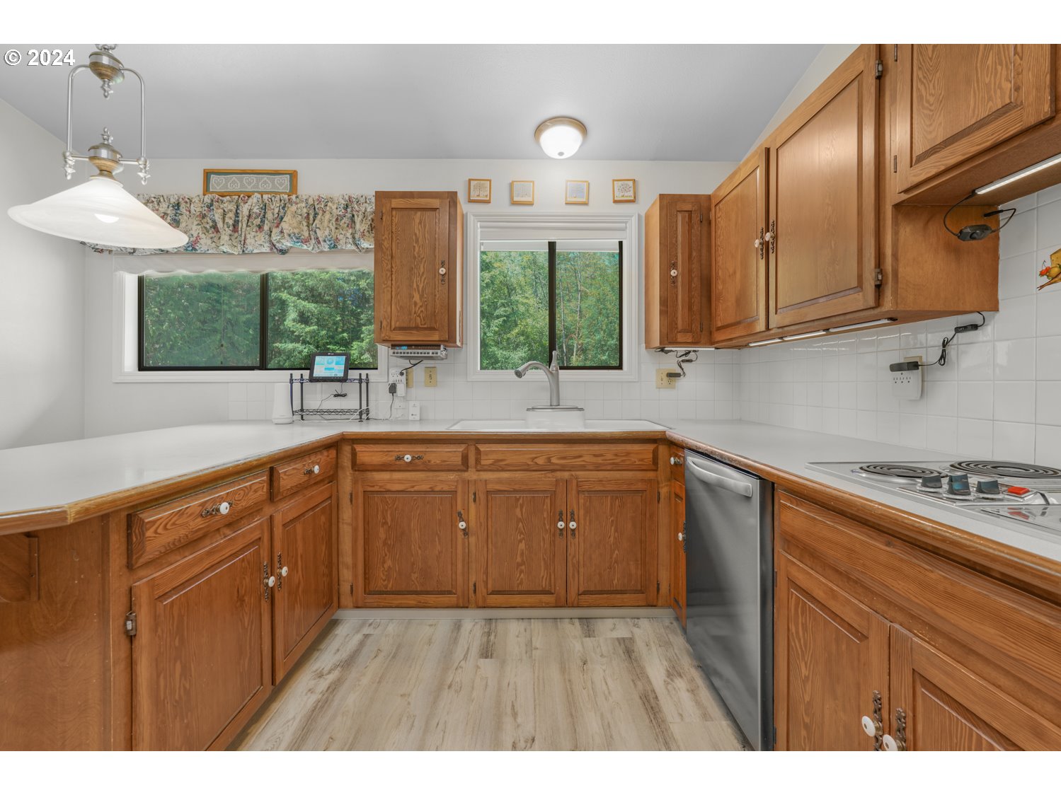 295 McAdams Road East Longview, WA 98632 - Photo 11 of 34 a kitchen with cabinets and window