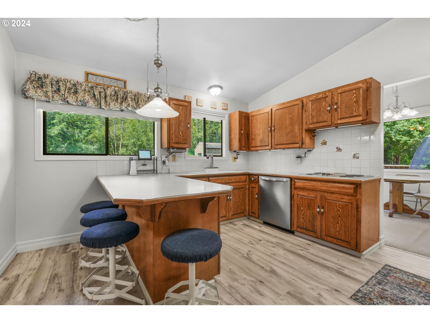 295 McAdams Road East Longview, WA 98632 - Photo 12 of 34 a kitchen with stainless steel appliances a table and chairs in it