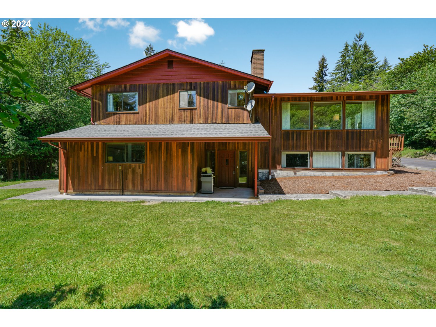 295 McAdams Road East Longview, WA 98632 - Photo 25 of 34 a view of a house with a yard and sitting area