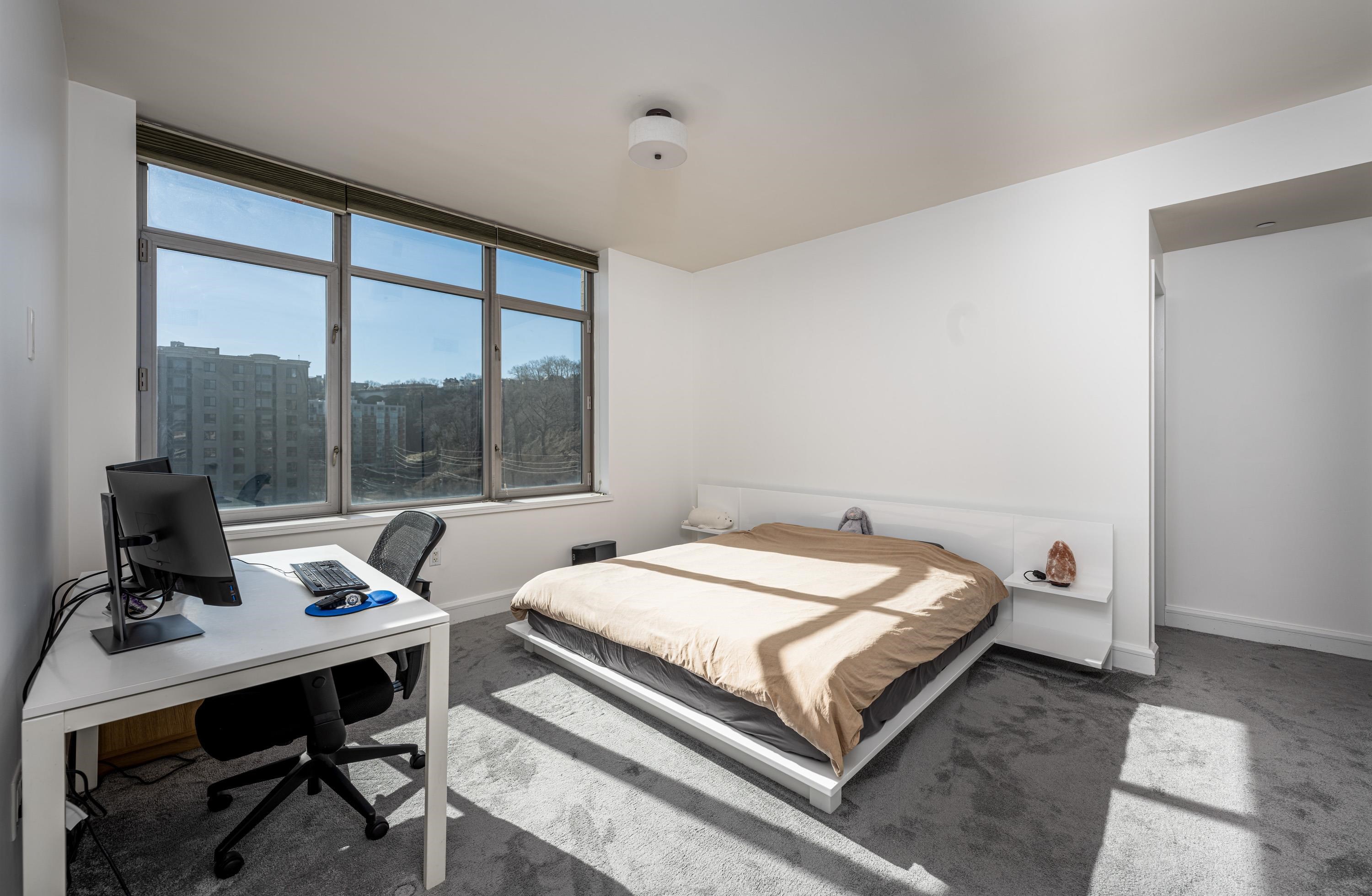 8100 River Road, Unit 810 North Bergen, NJ 07047 - Photo 5 of 20 a bed sitting in a bedroom next to a window