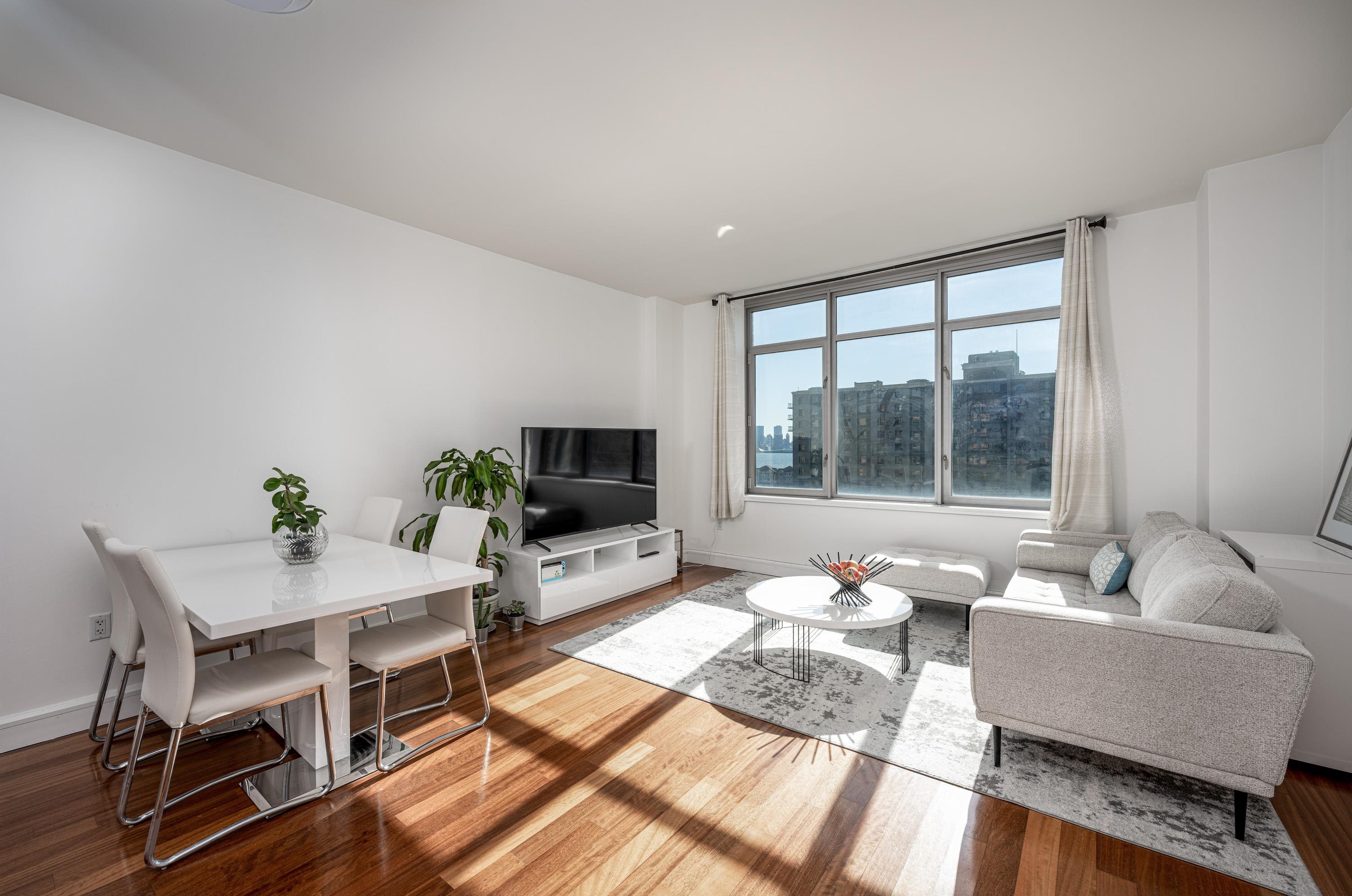 8100 River Road, Unit 810 North Bergen, NJ 07047 - Photo 7 of 20 a living room with furniture and a flat screen tv