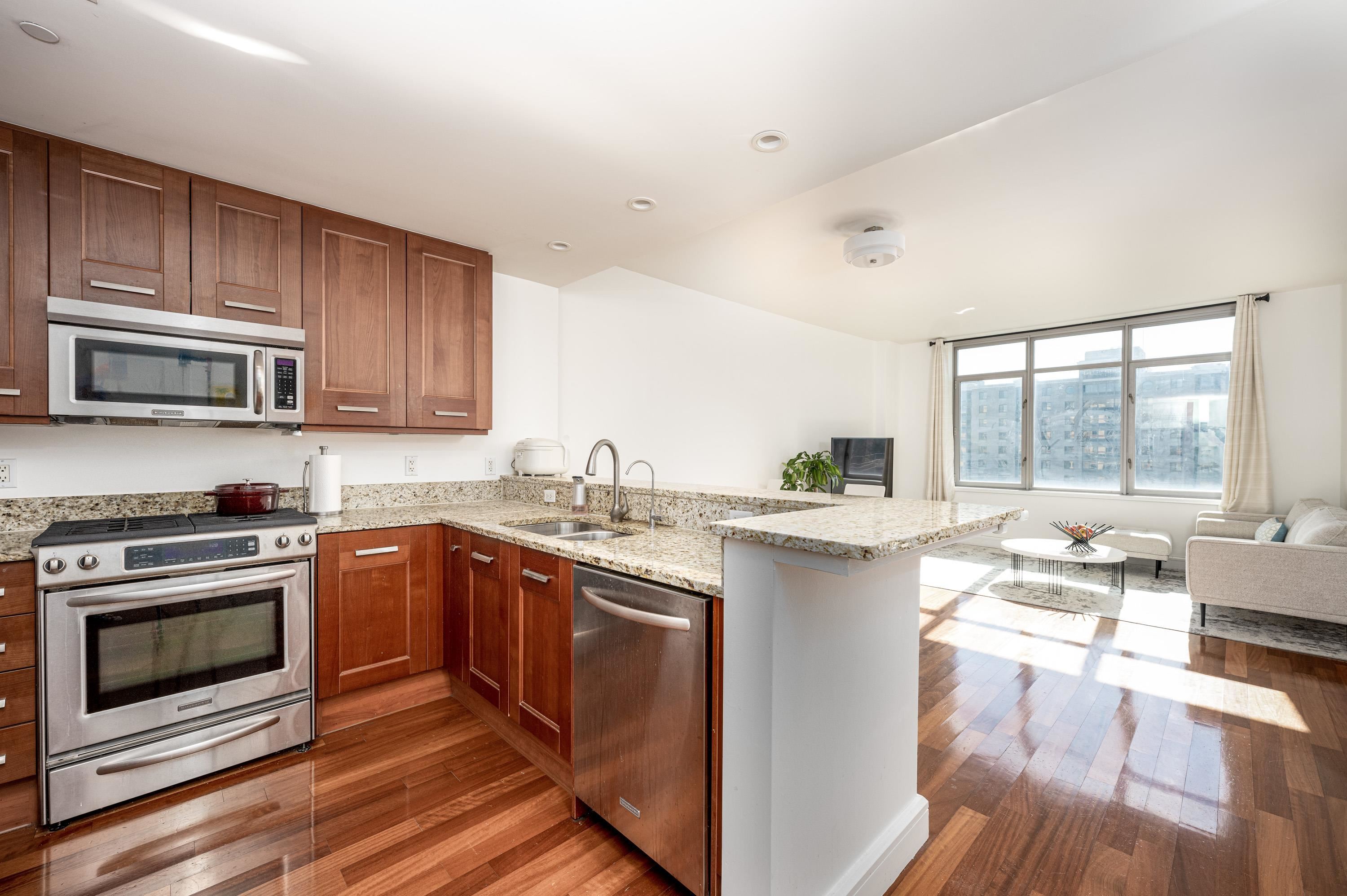 8100 River Road, Unit 810 North Bergen, NJ 07047 - Photo 9 of 20 a kitchen with a sink stove and cabinets