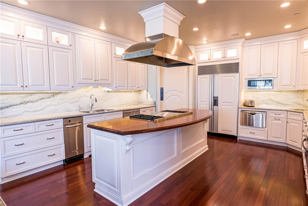 245 Saunders Station Road Trafford, PA 15085 - Photo 5 of 25 a kitchen with stainless steel appliances granite countertop a sink a stove and a wooden floors