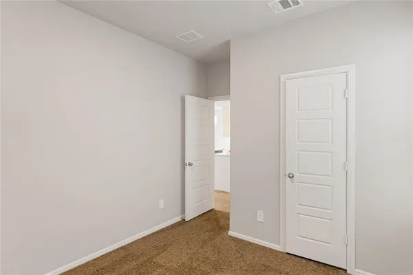 an empty room with closet area