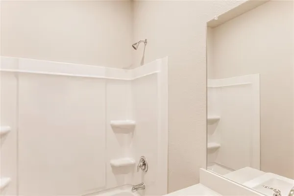 a bathroom with a shower a toilet and a sink