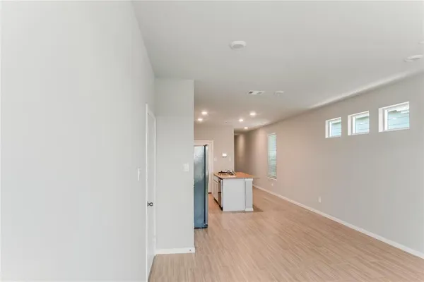 a view of a room with wooden floor and a ceiling fan