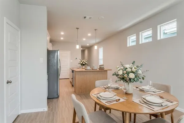 a dining room with furniture and wooden floor