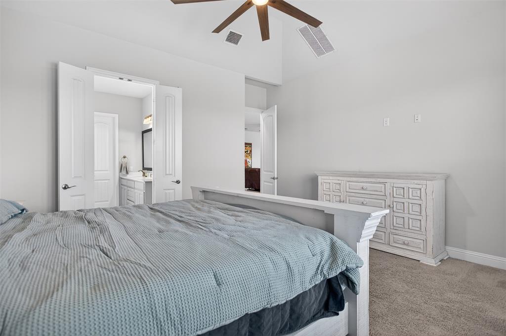6829 Danridge Road Rowlett, TX 75089 - Photo 11 of 28 a bedroom with a bed and a chandelier