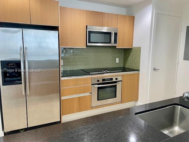 1050 Brickell Avenue, Unit 1602 Miami, FL 33131 - Photo 13 of 21 a kitchen with microwave and stove