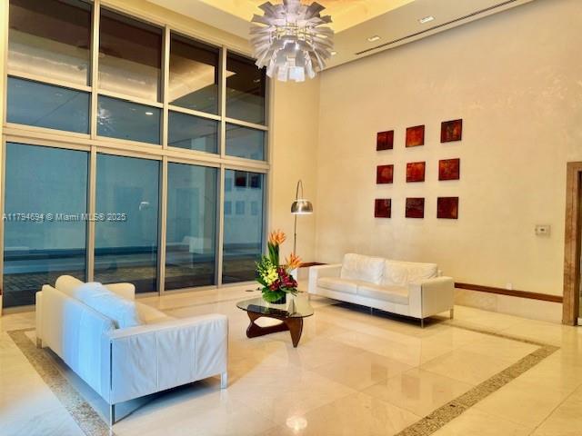 1050 Brickell Avenue, Unit 1602 Miami, FL 33131 - Photo 4 of 21 a living room with furniture and a large window