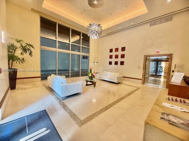 1050 Brickell Avenue, Unit 1602 Miami, FL 33131 - Photo 5 of 21 a living room with furniture and a flat screen tv