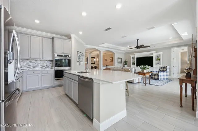 a large kitchen with stainless steel appliances kitchen island granite countertop a large counter top and stainless steel appliances