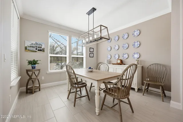 a view of a dining room with furniture and a chandelier