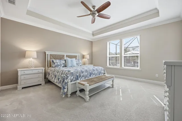 a bedroom with a bed dresser and window