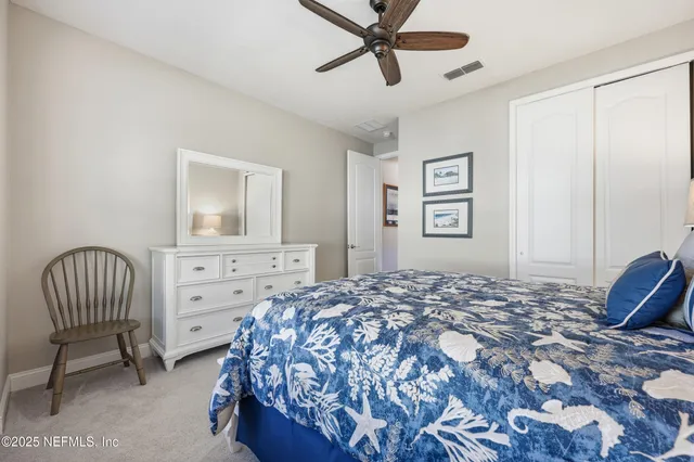 a bedroom with a bed and a chair