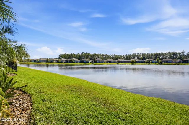 an aerial view of a house with a garden and swimming pool