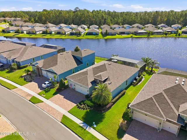 a view of a swimming pool with outdoor seating and a garden