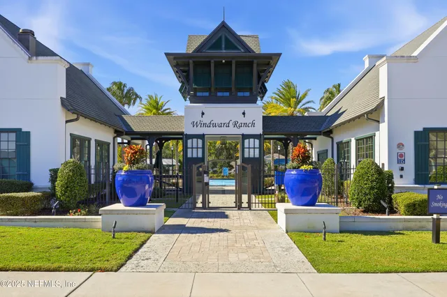 an aerial view of residential houses with outdoor space and trees