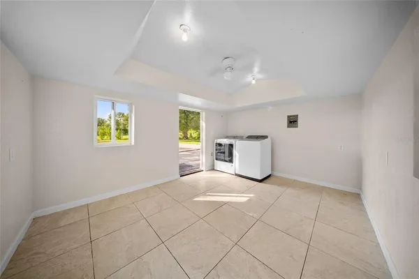 a view of an empty room with window and cabinet