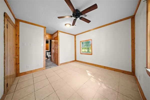 a view of a livingroom with a ceiling fan and window