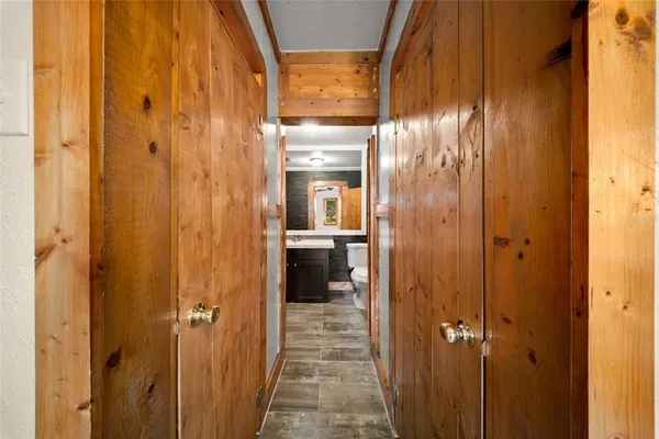 a view of a hallway with wooden floor