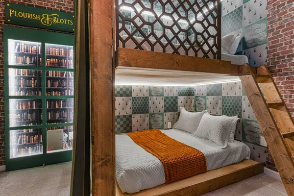 a bedroom with a bed and a book shelf