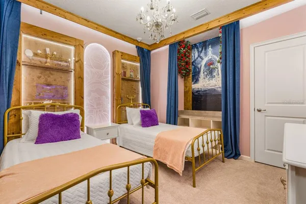 a bedroom with a bed and a chandelier